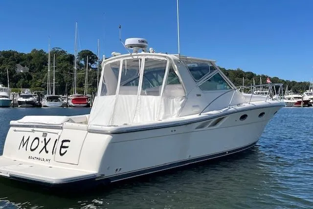 Moxie Yacht Photos Pics 1998 Tiara Yachts 3500 Open boat docked in a marina, clear blue sky.
