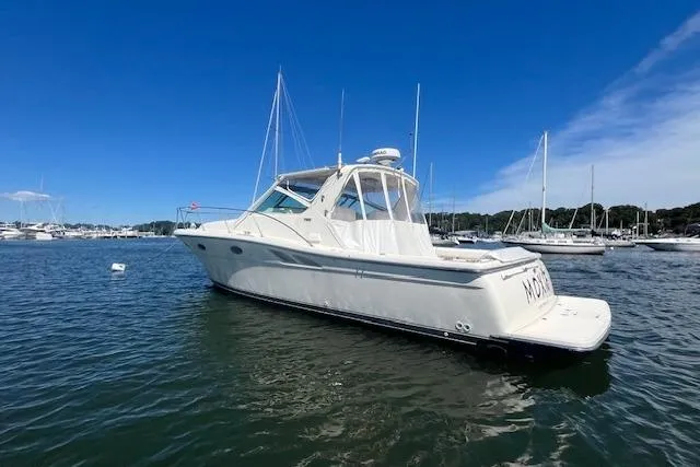 Moxie Yacht Photos Pics 1998 Tiara Yachts 3500 Open boat on calm water, clear sky background.