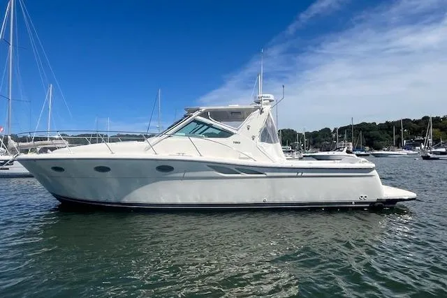 Moxie Yacht Photos Pics 1998 Tiara Yachts 3500 Open boat on calm water under a clear blue sky.