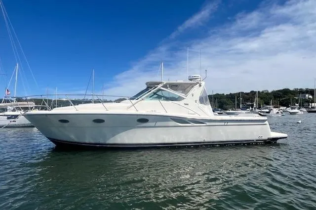 Moxie Yacht Photos Pics 1998 Tiara Yachts 3500 Open boat on calm water under a clear blue sky.
