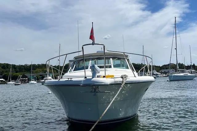 Moxie Yacht Photos Pics 1998 Tiara Yachts 3500 Open boat anchored in a scenic harbor.