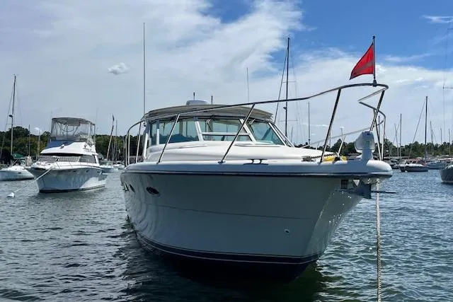 Moxie Yacht Photos Pics 1998 Tiara Yachts 3500 Open boat anchored in a marina under a clear sky.