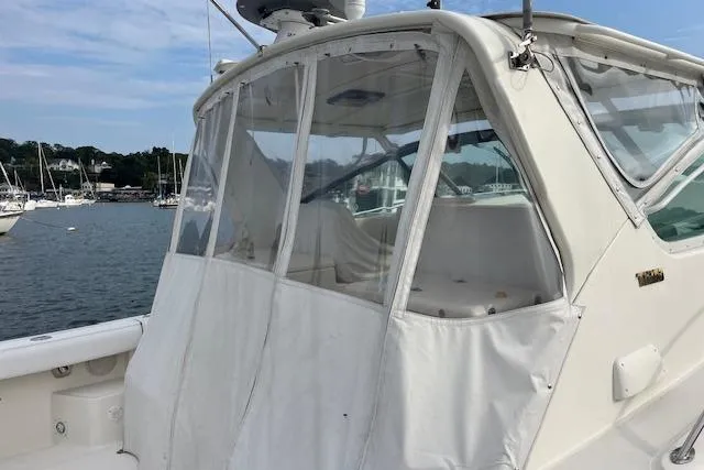 Moxie Yacht Photos Pics 1998 Tiara Yachts 3500 Open with clear enclosure, docked in a marina.