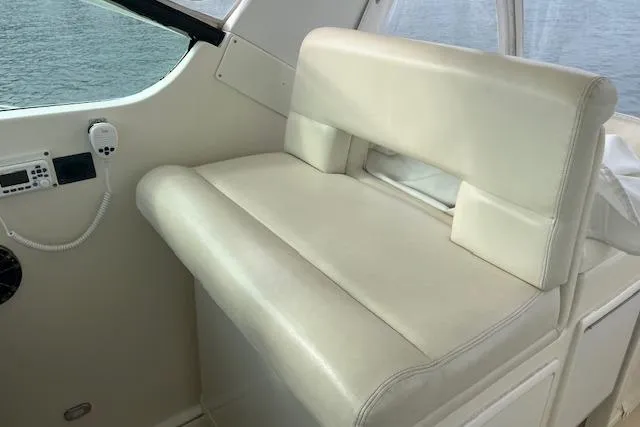 Moxie Yacht Photos Pics 1998 Tiara Yachts 3500 Open interior seating with white upholstery and control panel.