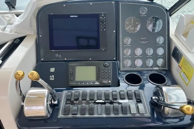 Moxie Yacht Photos Pics Control panel of a 1998 Tiara Yachts 3500 Open, featuring navigation and throttle controls.