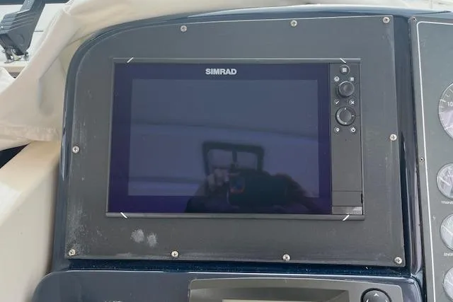 Moxie Yacht Photos Pics Simrad display on 1998 Tiara Yachts 3500 Open dashboard, showcasing navigation technology.