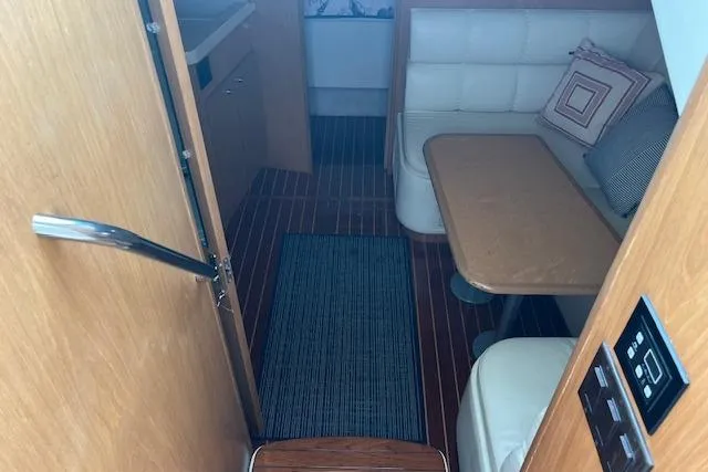 Moxie Yacht Photos Pics 1998 Tiara Yachts 3500 Open cabin interior with wood flooring and cushioned seating.