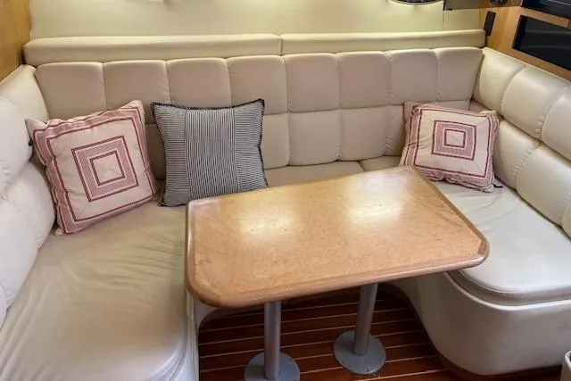 Moxie Yacht Photos Pics 1998 Tiara Yachts 3500 Open interior with beige seating and wooden table.