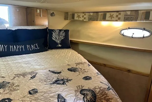 Moxie Yacht Photos Pics Cozy cabin interior of 1998 Tiara Yachts 3500 Open with nautical-themed bedding.