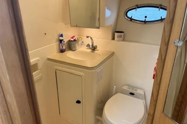 Moxie Yacht Photos Pics Bathroom interior of 1998 Tiara Yachts 3500 Open, featuring sink and toilet.