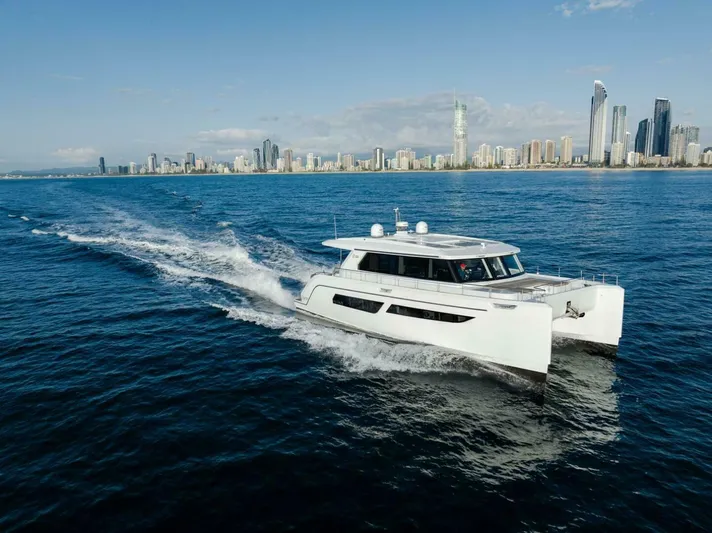 53s Iliad 2026 Yacht Photos Pics Luxury ILIAD 53S yacht cruising near a city skyline, 2026 model.