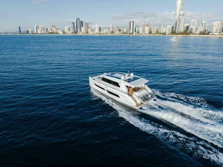 53s Iliad 2026 Yacht Photos Pics Luxury ILIAD 53S yacht cruising near a city skyline, 2026 model.