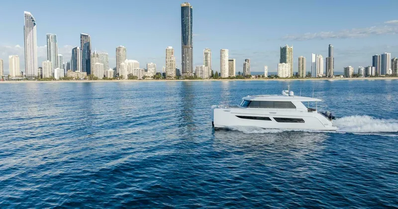 53s Iliad 2026 Yacht Photos Pics Luxury ILIAD 53S yacht cruising near a modern city skyline, 2026 model.