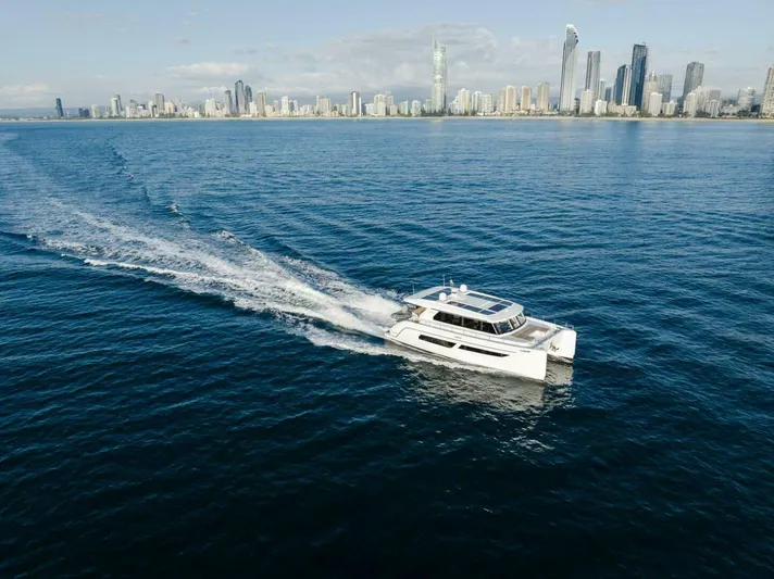 53s Iliad 2026 Yacht Photos Pics Luxury ILIAD 53S yacht cruising near a modern city skyline, 2026 model.