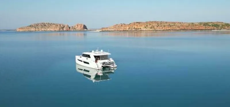 53s Iliad 2026 Yacht Photos Pics Luxury ILIAD 53S yacht on serene waters, 2026 model, with scenic island backdrop.