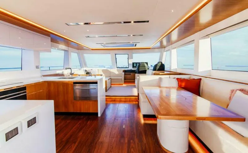 53s Iliad 2026 Yacht Photos Pics Luxurious interior of 2026 ILIAD 53S yacht with modern kitchen and seating area.