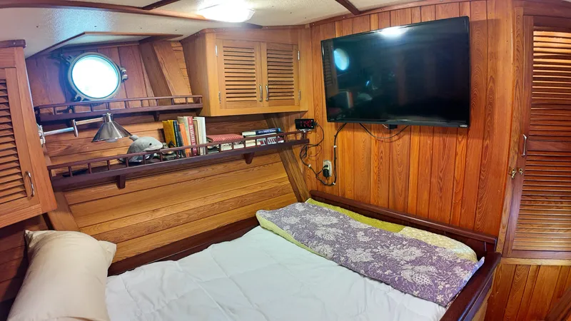 La Vita Marina Yacht Photos Pics Cozy cabin interior of 1993 Holland Marine 50 Custom Trawler with wood paneling and TV.