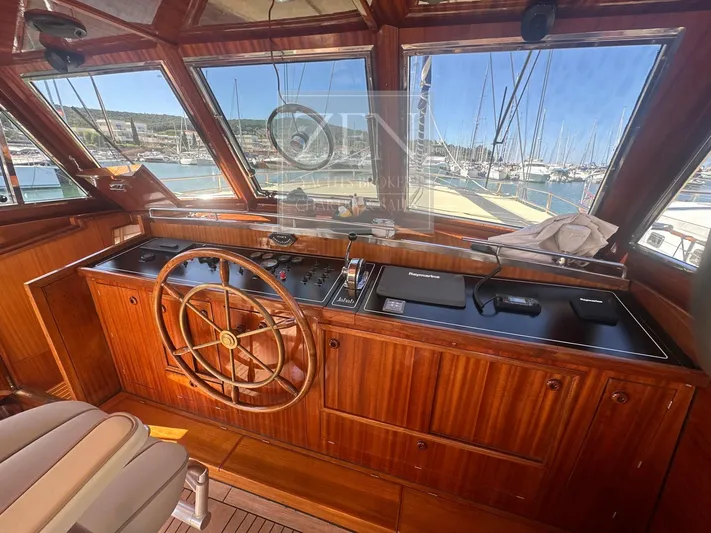  Yacht Photos Pics Wooden helm of 1987 Galtarossa Motorsailer, showcasing classic design and marina view.