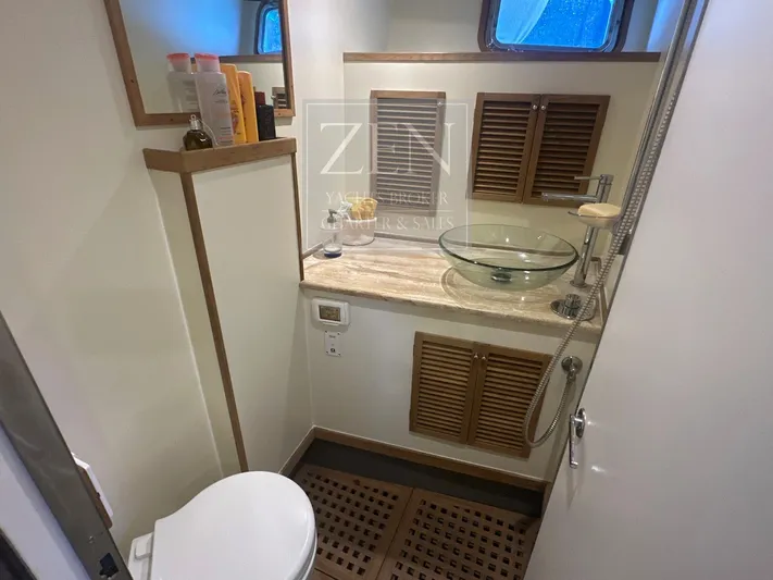  Yacht Photos Pics Bathroom interior of 1987 Galtarossa Motorsailer yacht with glass sink and wooden accents.