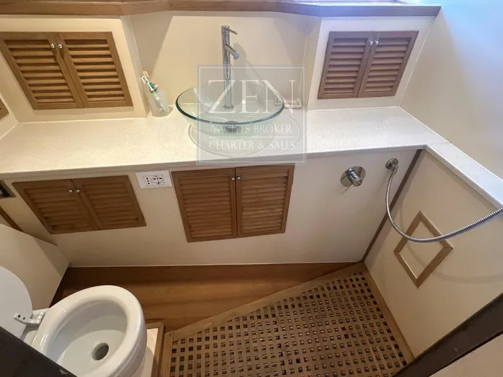  Yacht Photos Pics Bathroom interior of 1987 Galtarossa Motorsailer, featuring wooden cabinets and modern fixtures.