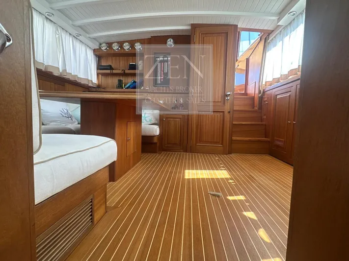  Yacht Photos Pics Interior of 1987 Galtarossa Motorsailer, featuring wooden furnishings and cozy seating.
