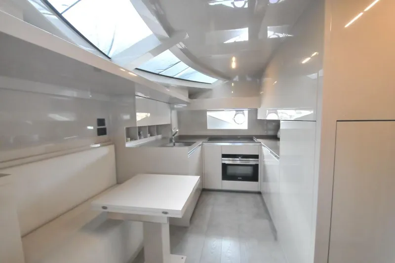  Yacht Photos Pics Modern kitchen interior of 2017 Ferretti Yachts 850, featuring sleek white design and ample natural light.