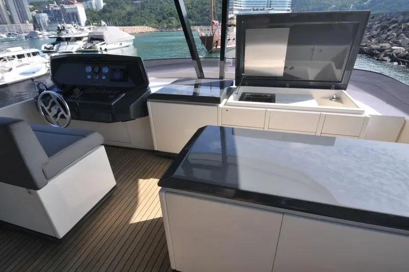  Yacht Photos Pics Luxurious 2017 Ferretti Yachts 850 helm and outdoor kitchen area with scenic marina view.