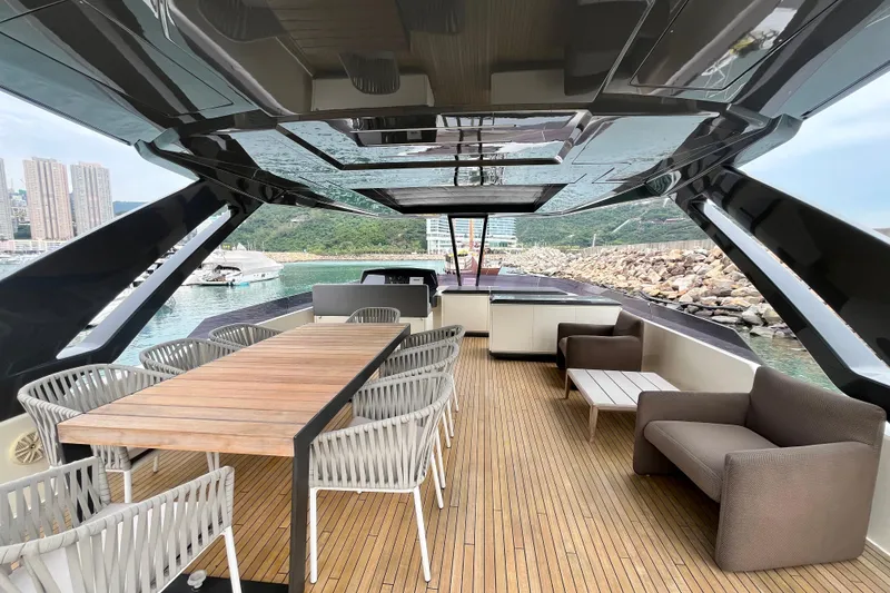  Yacht Photos Pics Luxurious 2017 Ferretti Yachts 850 deck with elegant seating and scenic waterfront view.