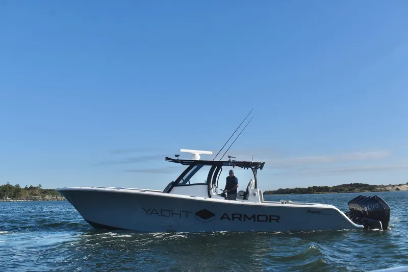 Main Event Yacht Photos Pics 2023 Front Runner 39 Center Console boat cruising on open water under clear blue sky.