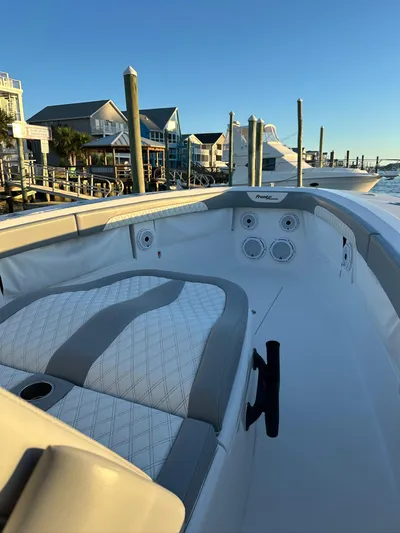 Main Event Yacht Photos Pics 2023 Front Runner 39 Center Console boat docked at marina, featuring elegant seating and coastal backdrop.