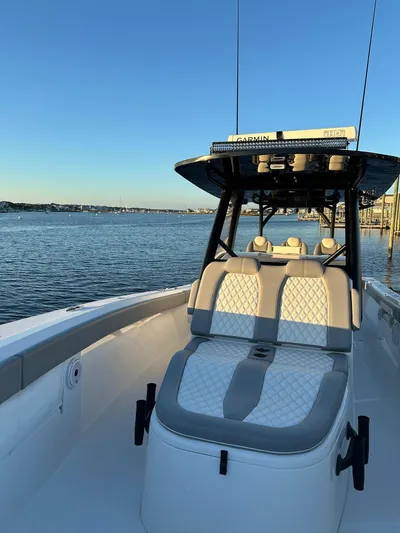 Main Event Yacht Photos Pics 2023 Front Runner 39 Center Console boat on calm water at sunset.