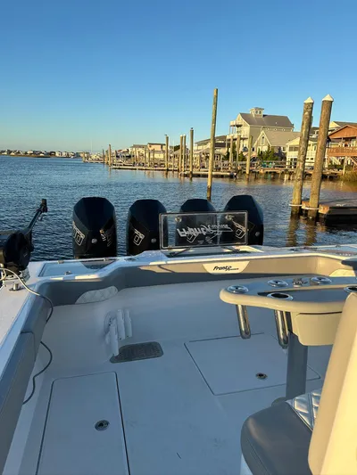Main Event Yacht Photos Pics 2023 Front Runner 39 Center Console boat docked by waterfront homes.