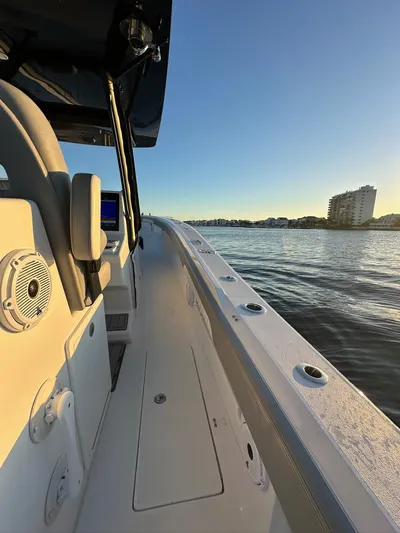 Main Event Yacht Photos Pics 2023 Front Runner 39 Center Console boat on calm water at sunset.