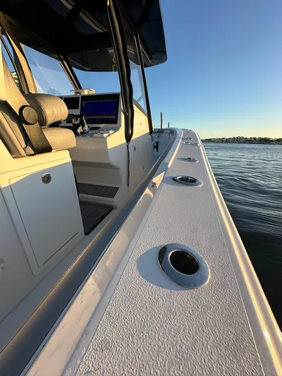 Main Event Yacht Photos Pics 2023 Front Runner 39 Center Console boat on calm water at sunset.