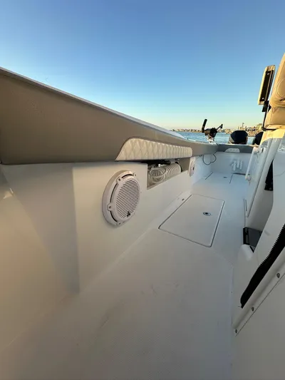 Main Event Yacht Photos Pics 2023 Front Runner 39 Center Console boat interior with speaker and storage compartments.