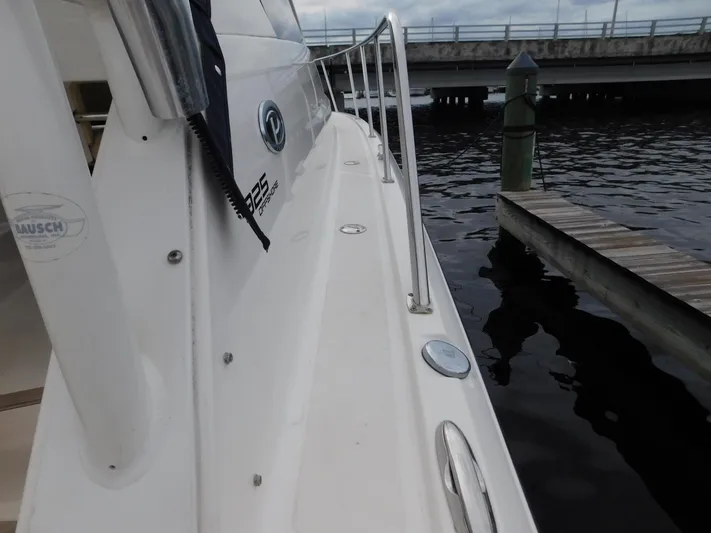 Yacht Photos Pics 2018 Pursuit OS 325 Offshore boat docked by the water.