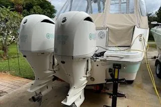  Yacht Photos Pics 2021 Robalo R300 Center Console boat with dual outboard engines, parked outdoors.