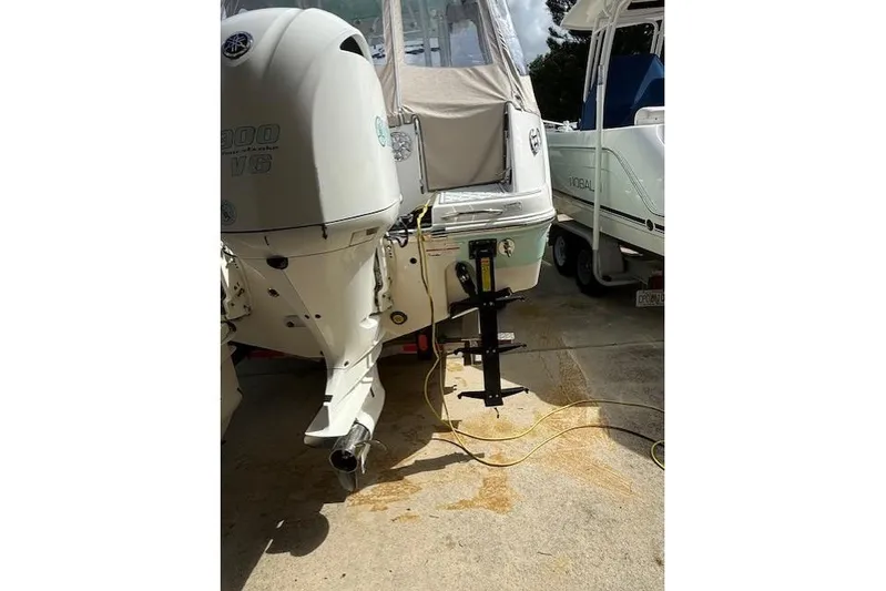  Yacht Photos Pics 2021 Robalo R300 Center Console boat with Yamaha outboard engine in a driveway.