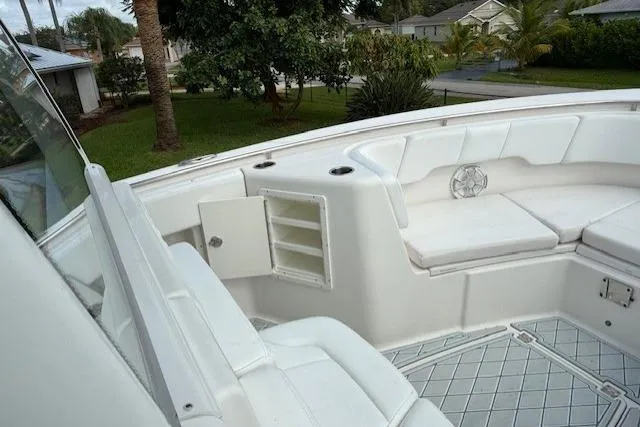 Yacht Photos Pics 2021 Robalo R300 Center Console boat interior with white seating and storage compartments.