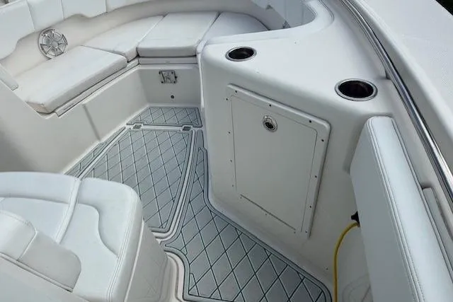  Yacht Photos Pics 2021 Robalo R300 Center Console boat interior with cushioned seating and storage.