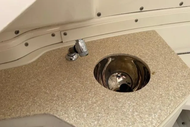  Yacht Photos Pics 2021 Robalo R300 Center Console boat sink with faucet on beige countertop.
