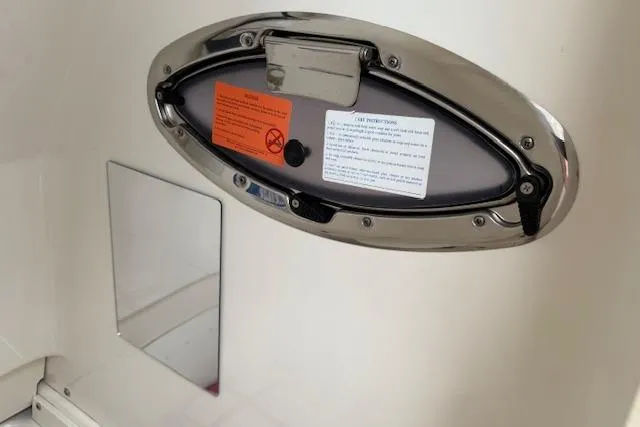  Yacht Photos Pics 2021 Robalo R300 Center Console boat hatch with safety instructions and warning labels.