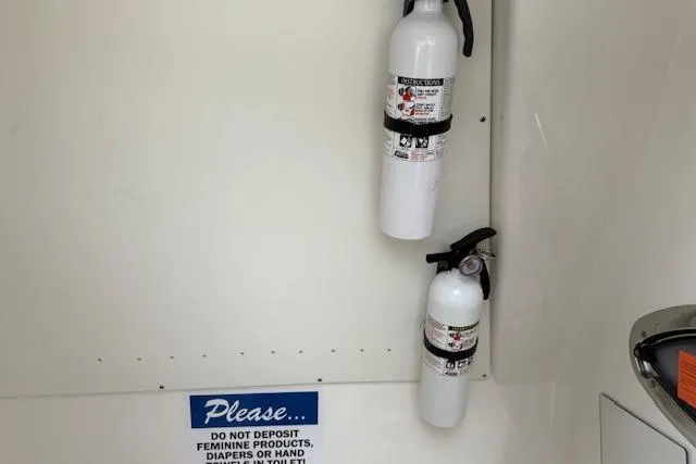  Yacht Photos Pics Fire extinguishers on a 2021 Robalo R300 Center Console boat with safety notice.