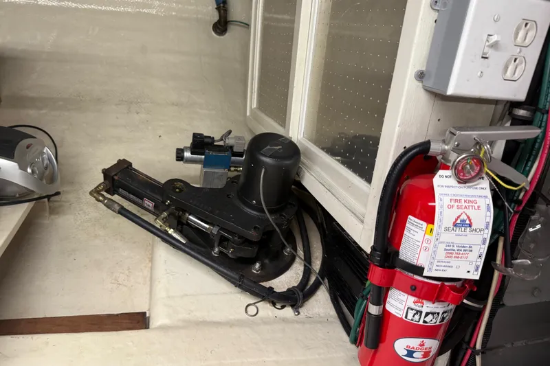  Yacht Photos Pics Engine room of 1998 Kadey-Krogen 48' Northsea Widebody Pilothouse with fire extinguisher.