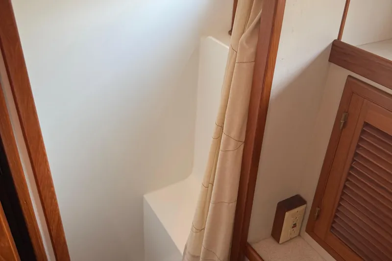 Yacht Photos Pics 1998 Kadey-Krogen 48' Northsea Pilothouse bathroom with wooden accents and shower curtain.