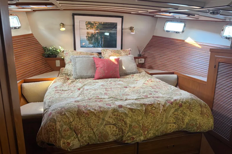  Yacht Photos Pics Cozy bedroom in 1998 Kadey-Krogen 48' Northsea Widebody Pilothouse with floral bedding and wood accents.