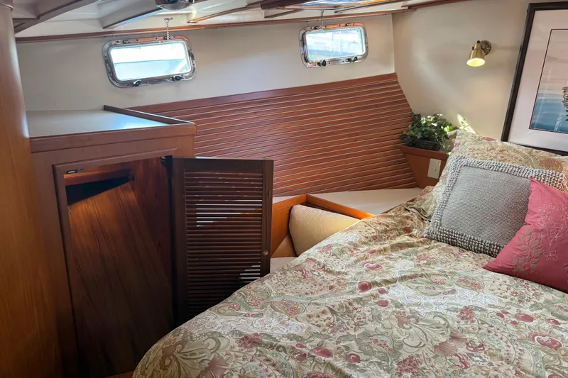  Yacht Photos Pics Cozy bedroom in 1998 Kadey-Krogen 48' Northsea Widebody Pilothouse with floral bedding.
