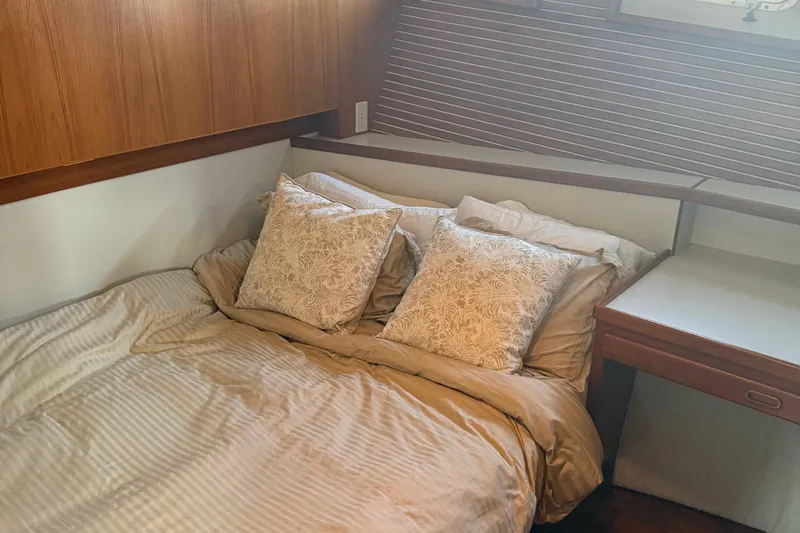 Yacht Photos Pics Cozy bedroom in 1998 Kadey-Krogen 48' Northsea Widebody Pilothouse yacht with elegant bedding.