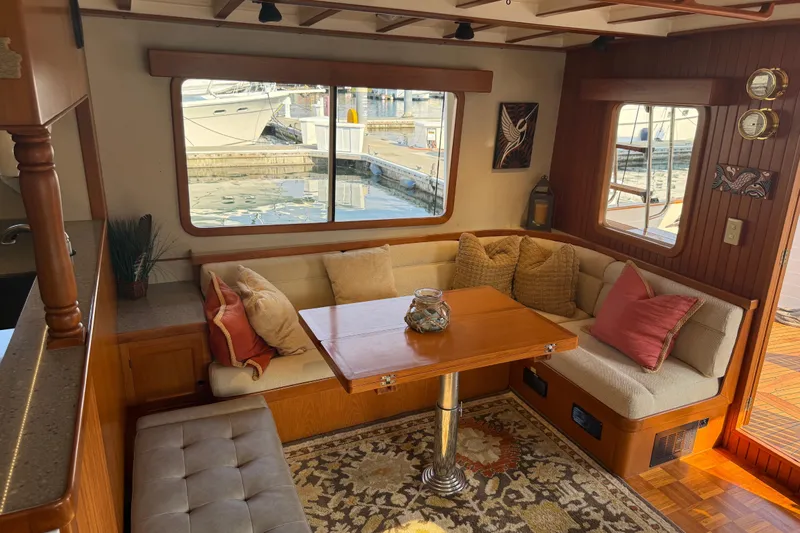  Yacht Photos Pics Cozy interior of 1998 Kadey-Krogen 48' Northsea Widebody Pilothouse with plush seating and wooden accents.