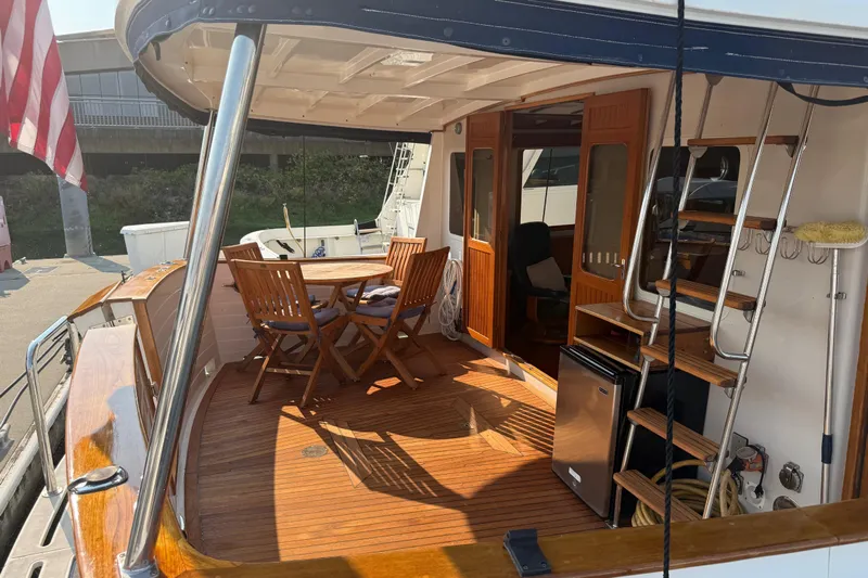  Yacht Photos Pics 1998 Kadey-Krogen 48' Northsea Widebody Pilothouse with wooden deck and outdoor seating area.